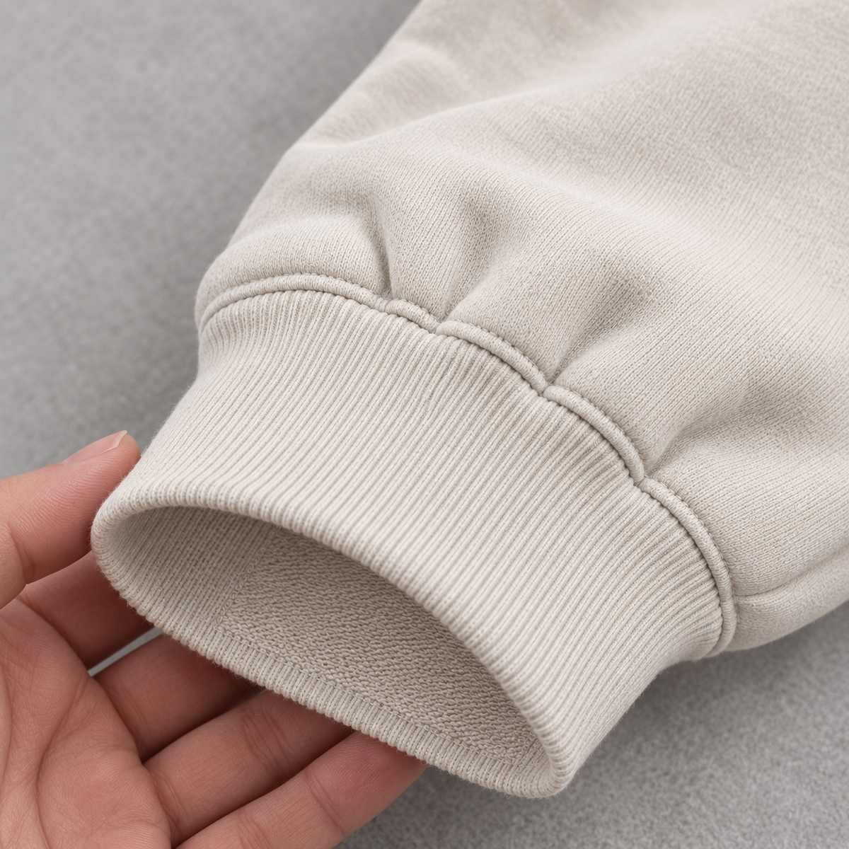 Close-up of the ribbed sleeve cuff on off-white oversized sweatshirt