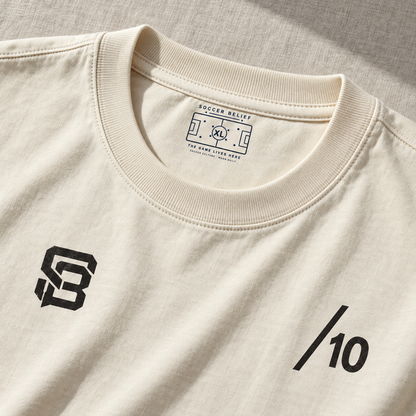 Close-up of the front neck label and number 10 chest print on off-white oversized T-shirt