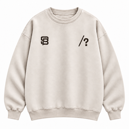 Close-up of customizable question mark graphic on the front of a cream oversized crewneck sweatshirt