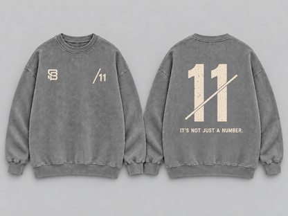 Front and back views of grey washed oversized sweatshirt with number 11 graphic